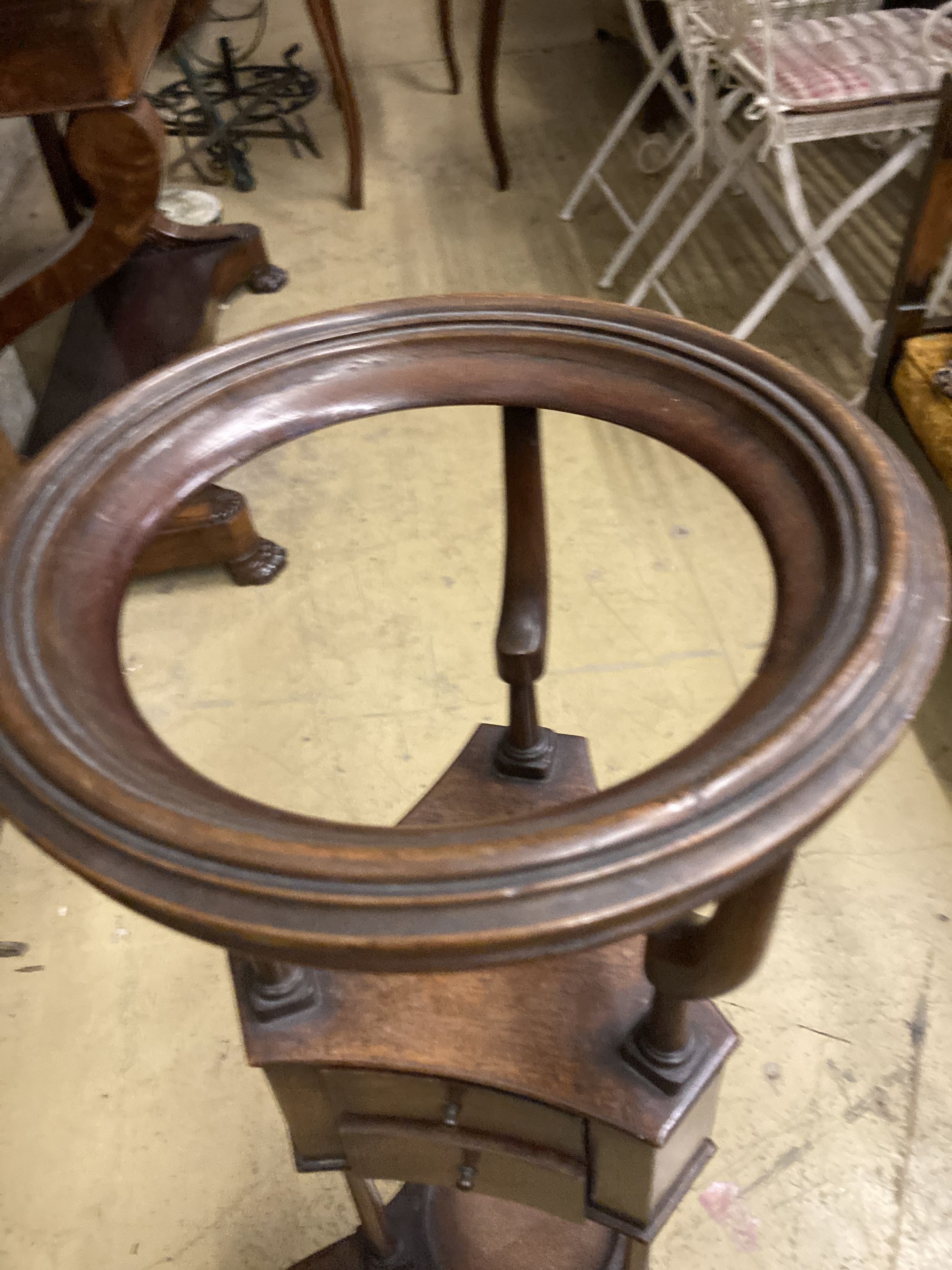 A George II style mahogany washstand, with open bowl stand over two triangular soap drawers and a jug platform, raised on cabriole legs